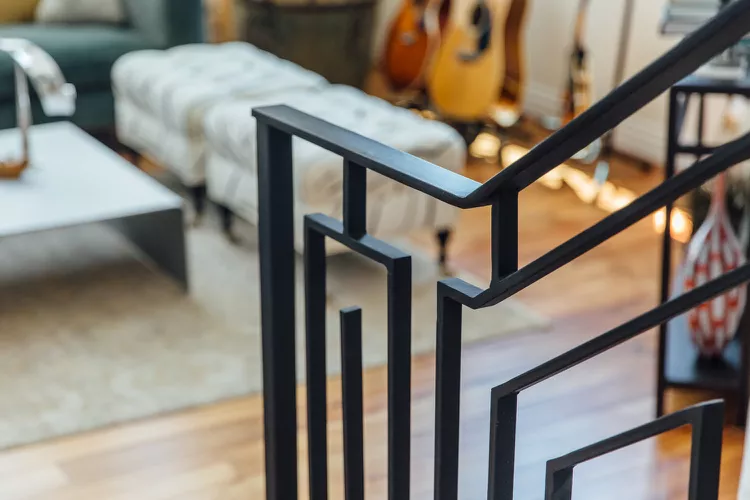 Art Deco stair railing showing luxurious, geometric matte black iron stair railing ideas indoor in a stylish home.