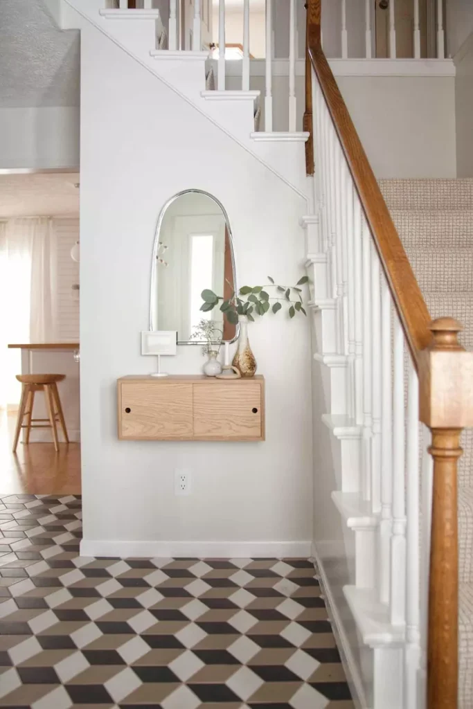 DIY painted white wood spindle railing next to a cozy entryway vanity, highlighting budget-friendly stair railing ideas outdoor and indoor.