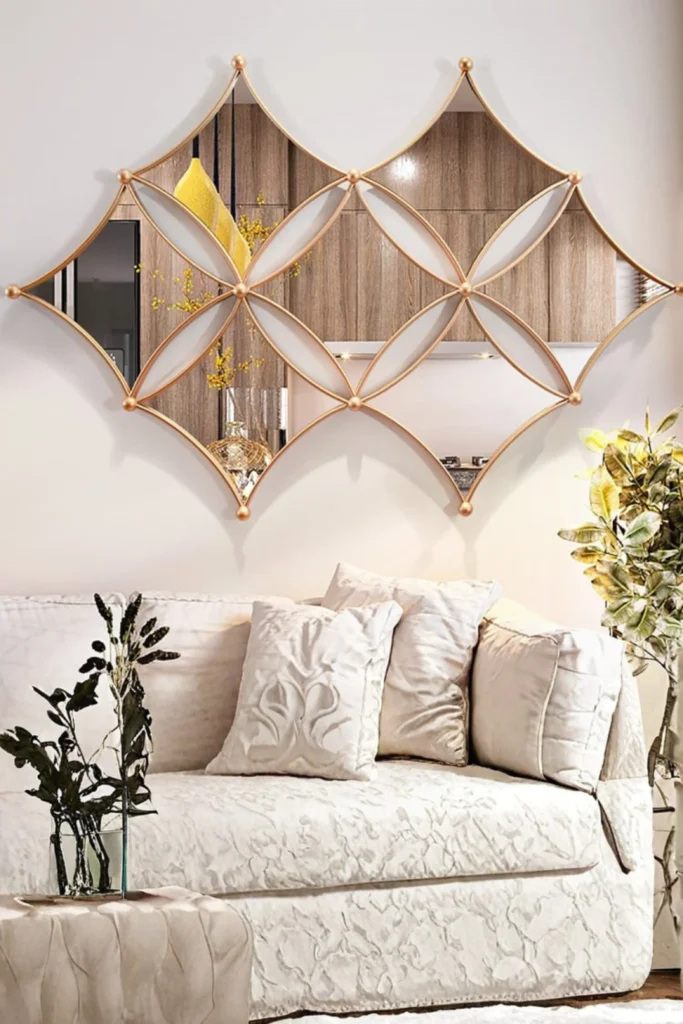 A sophisticated living room feature wall displaying large Geometric Metal Mirrors with a gold diamond-lattice metal frame mounted above a plush neutral sofa.