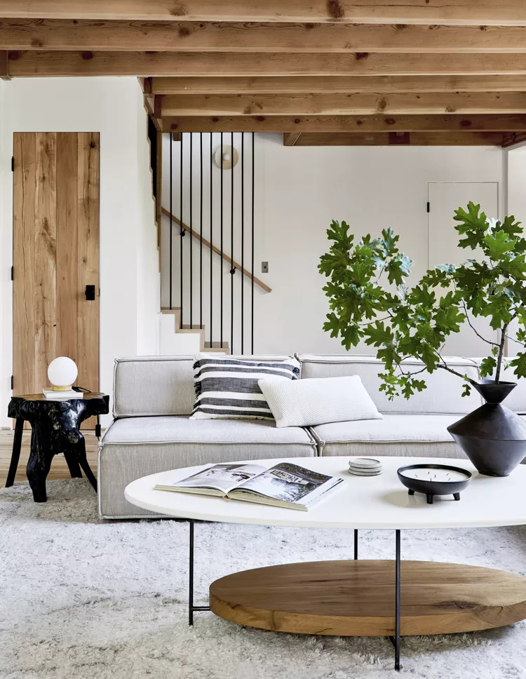 Modern minimalist iron bar stairs featuring vertical black metal stair railing ideas indoor in a cozy, rustic-modern living room.